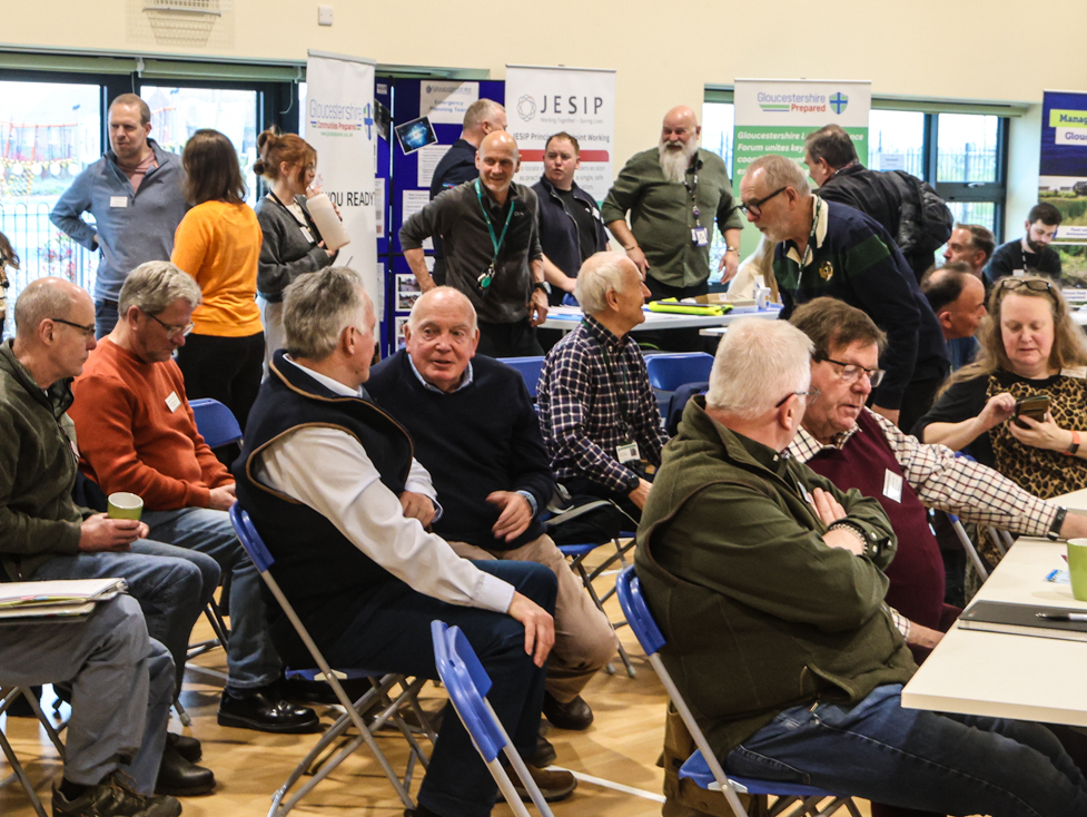 Flood wardens, statutory services staff, and emergency organisation volunteers chatting at the event